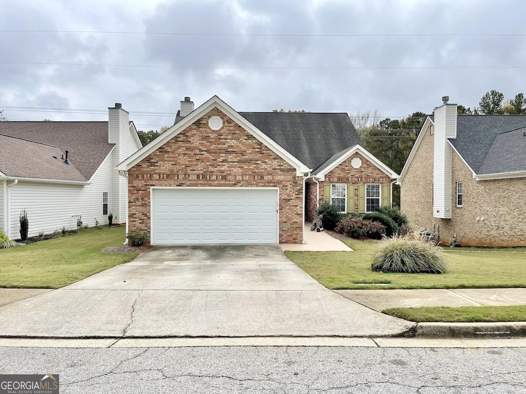 view of front facade with a garage and a front lawn