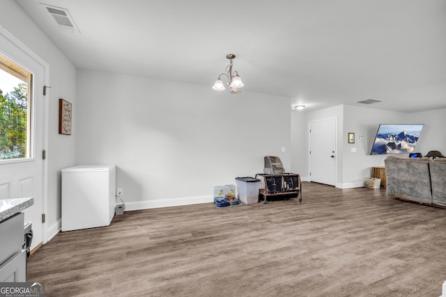 interior space featuring a notable chandelier and hardwood / wood-style flooring