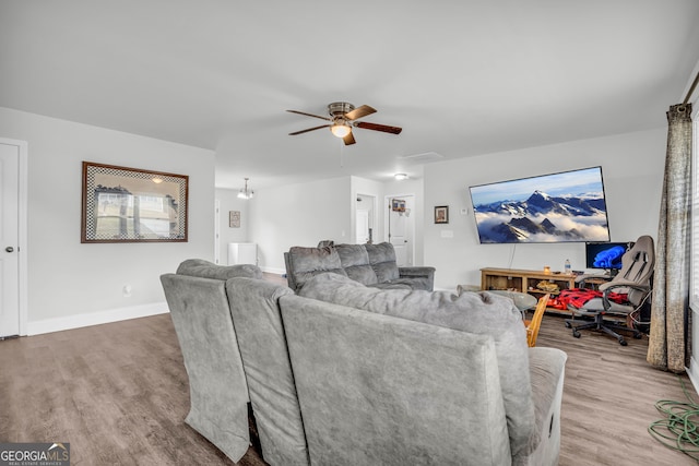 living room featuring hardwood / wood-style floors and ceiling fan