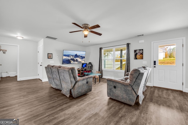 living room with ceiling fan, dark hardwood / wood-style floors, and plenty of natural light