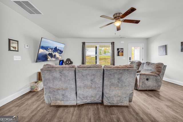 living room featuring hardwood / wood-style floors and ceiling fan