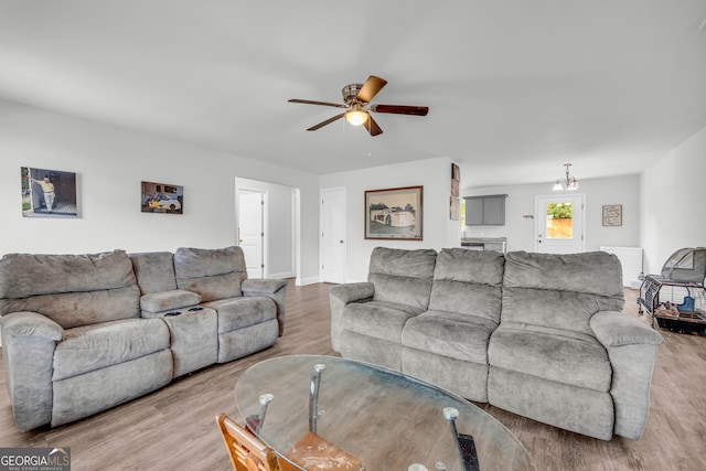 living room featuring hardwood / wood-style floors and ceiling fan