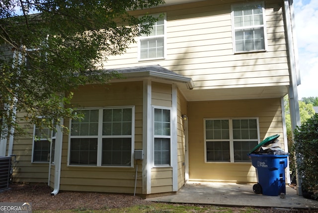 back of property featuring central air condition unit and a patio area