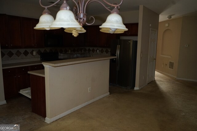 kitchen featuring dark brown cabinets, stainless steel refrigerator with ice dispenser, and decorative backsplash