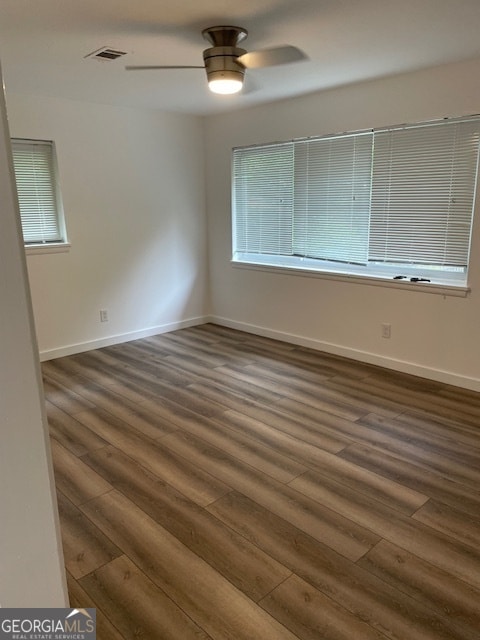 unfurnished room featuring ceiling fan and dark hardwood / wood-style flooring