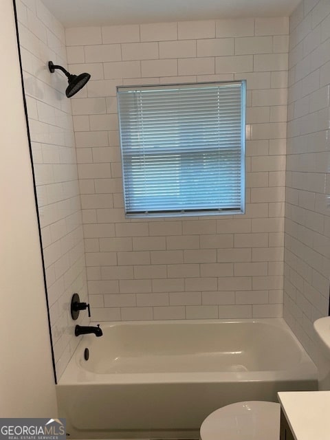 full bathroom with vanity, toilet, and tiled shower / bath