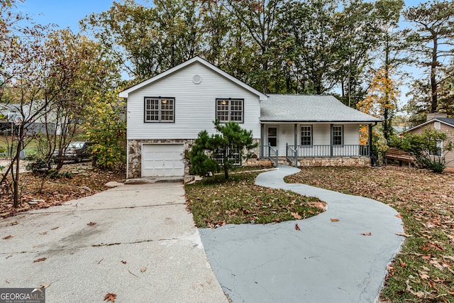 split level home featuring a garage and a porch