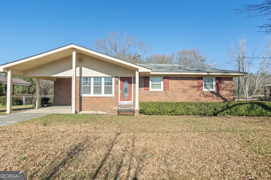 427 Moye Dr, Sandersville, GA 31082 - ranch-style home with a front lawn and a carport