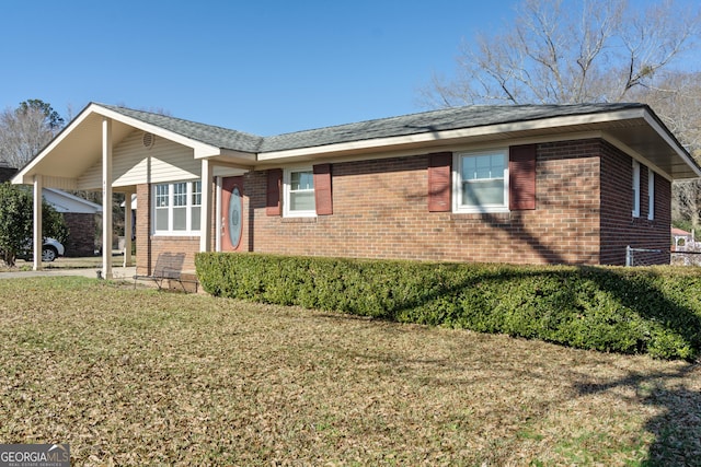 view of side of home with a yard