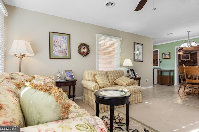 living room with ceiling fan with notable chandelier and light tile patterned flooring