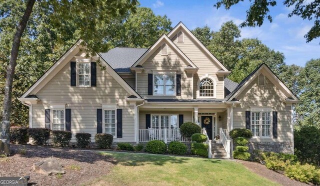 view of front of house with covered porch and a front yard