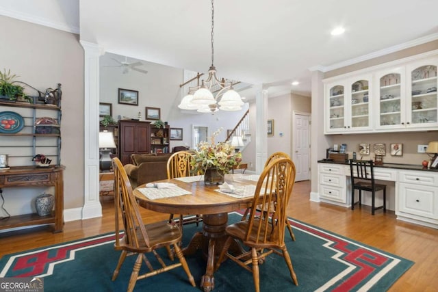 dining room with a ceiling fan, wood finished floors, ornate columns, built in study area, and recessed lighting
