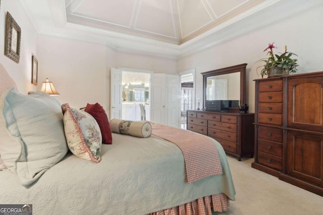 bedroom featuring light carpet, coffered ceiling, ensuite bathroom, and crown molding