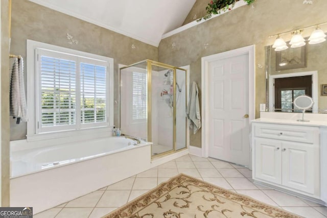bathroom with tile patterned flooring, a garden tub, vaulted ceiling, a stall shower, and vanity
