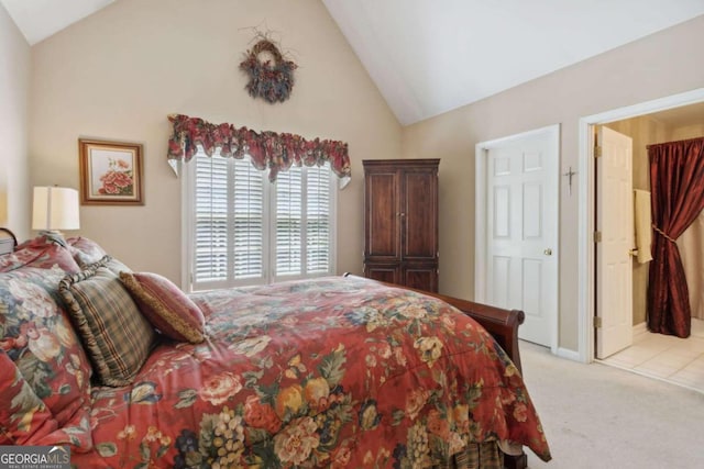 bedroom featuring light colored carpet and high vaulted ceiling