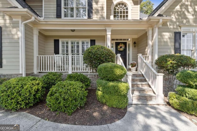 view of exterior entry featuring a porch