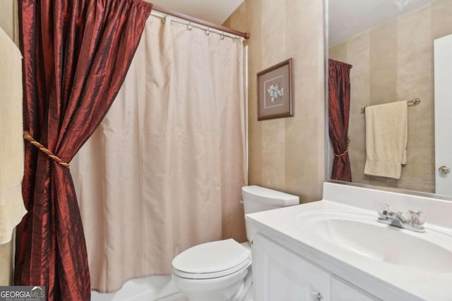 bathroom with a shower with shower curtain, toilet, and vanity