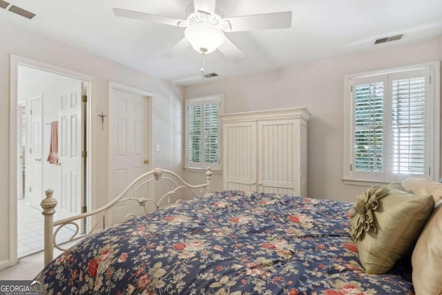 carpeted bedroom featuring multiple windows, a ceiling fan, and visible vents