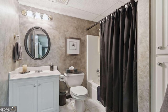 bathroom with toilet, shower / tub combo, tile patterned floors, vanity, and a paneled ceiling