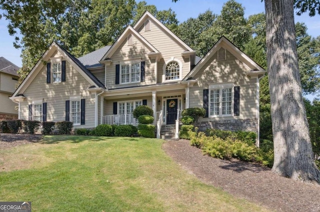 view of front facade with a front yard and a porch