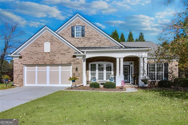 view of front of property with a front lawn, a garage, and covered porch