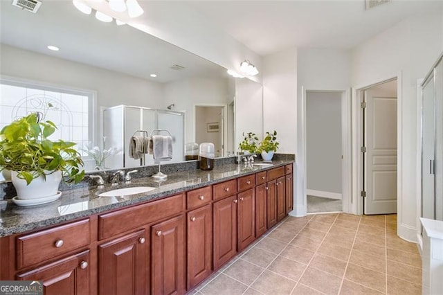 bathroom featuring vanity, an enclosed shower, and tile patterned flooring