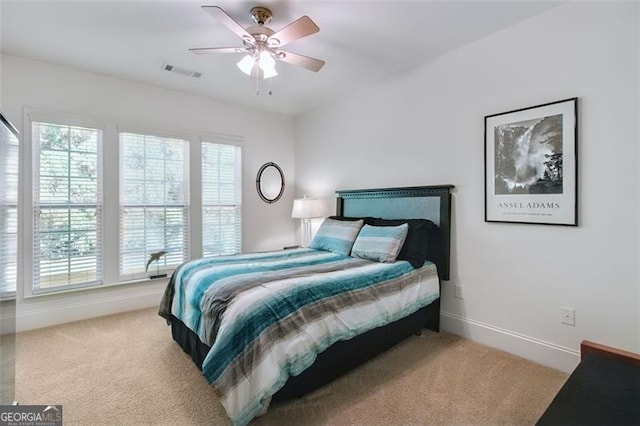 bedroom with light carpet and ceiling fan