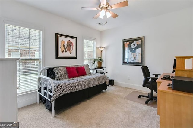 bedroom featuring light colored carpet and ceiling fan