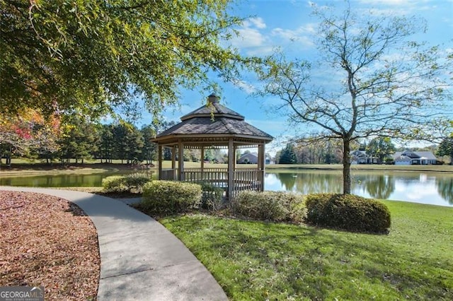 surrounding community with a water view, a yard, and a gazebo