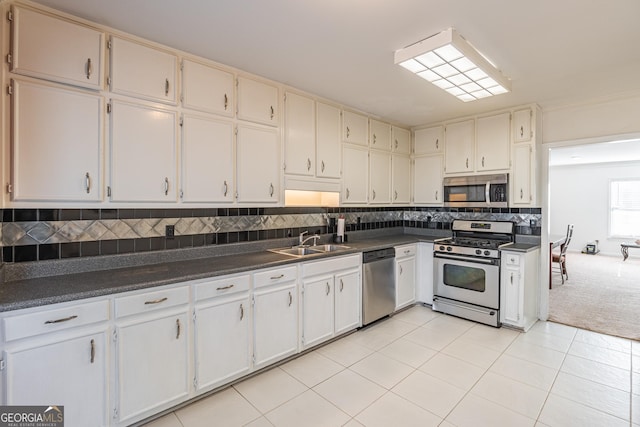 kitchen featuring white cabinetry, sink, light carpet, and appliances with stainless steel finishes