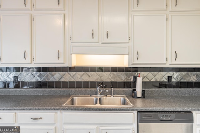 kitchen featuring backsplash, white cabinets, sink, and dishwasher