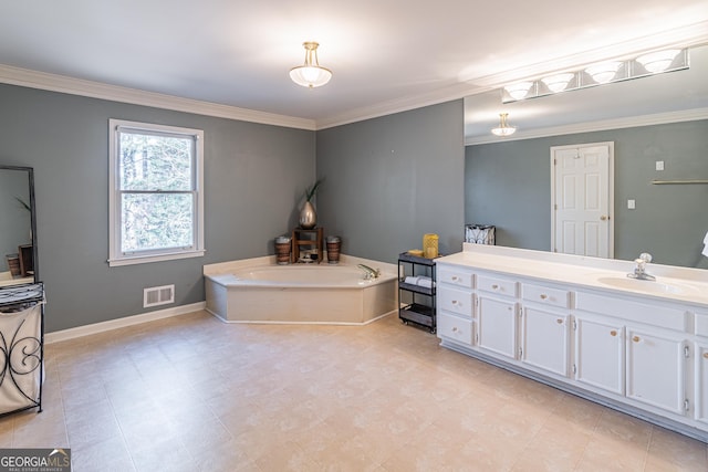 bathroom with ornamental molding, vanity, and a bathtub