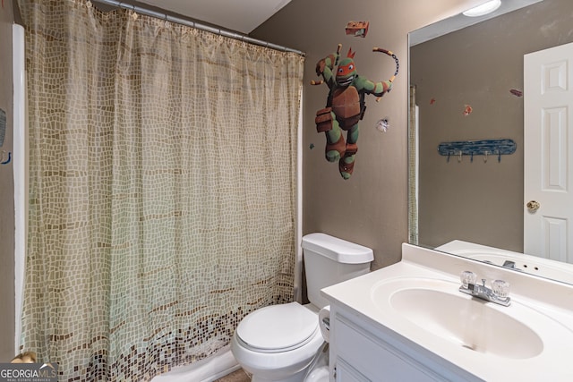 bathroom featuring walk in shower, vanity, and toilet