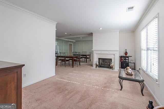 carpeted living room with crown molding and a wealth of natural light