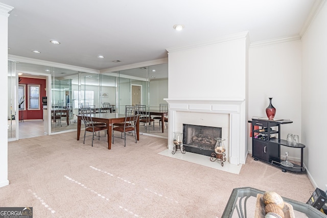 dining area with ornamental molding and carpet flooring