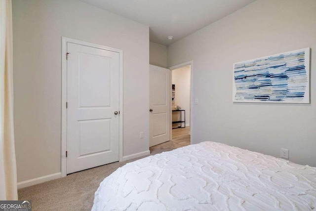 bedroom featuring light carpet