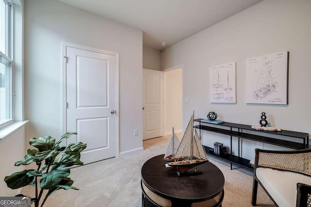 living area with light colored carpet