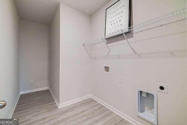 washroom featuring light hardwood / wood-style floors, hookup for a washing machine, and electric dryer hookup