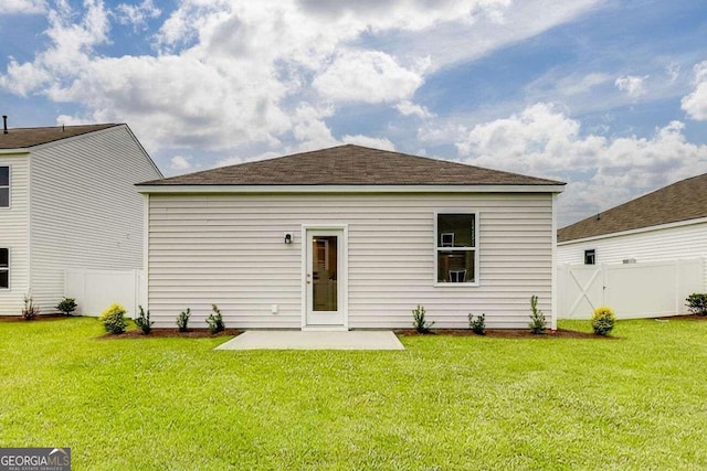 back of property featuring a yard and a patio area