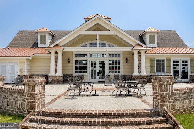 rear view of property with french doors and a patio area