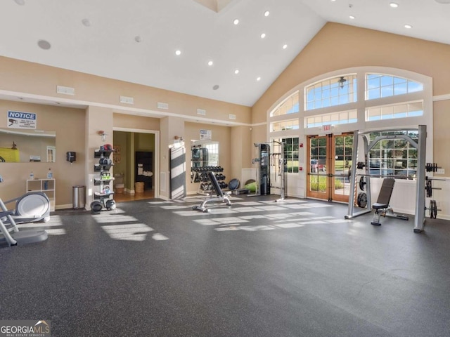 exercise room with french doors and a high ceiling