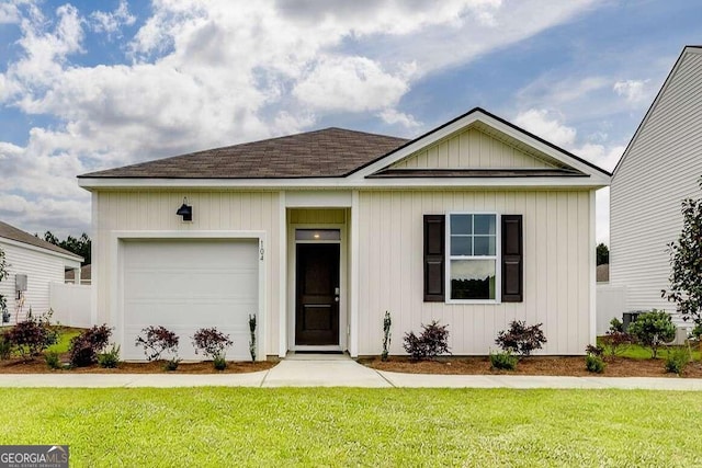 view of front of property featuring a garage and a front yard