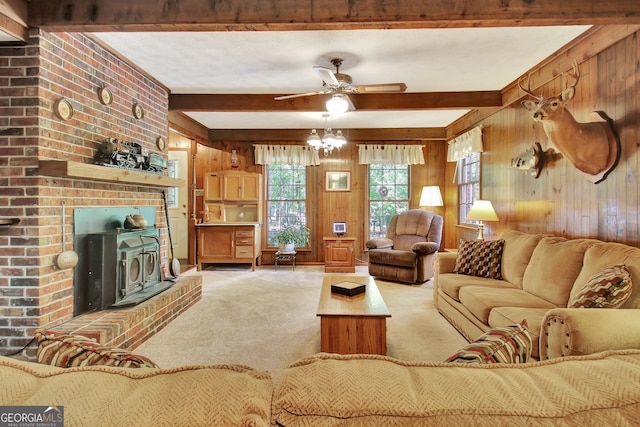 living room featuring wood walls, beamed ceiling, carpet flooring, and ceiling fan