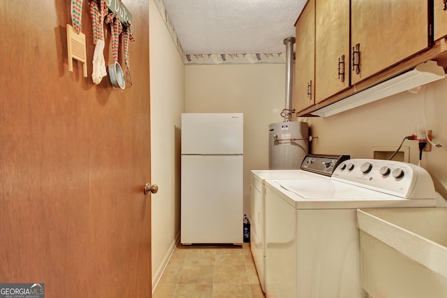 washroom featuring separate washer and dryer, cabinets, water heater, a textured ceiling, and sink