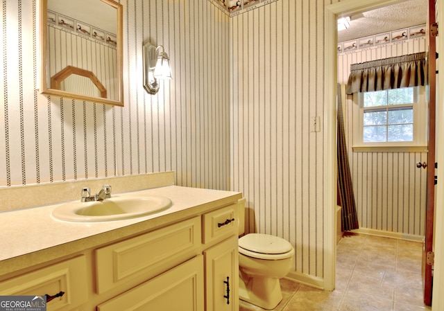 full bathroom with shower / bath combination with curtain, vanity, a textured ceiling, tile patterned flooring, and toilet