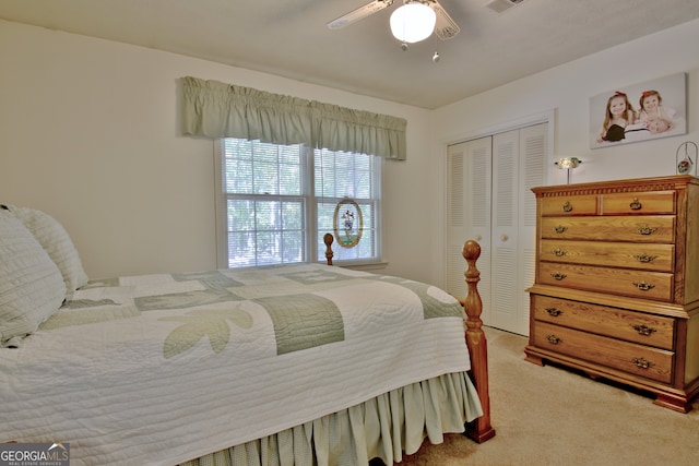 carpeted bedroom with ceiling fan and a closet