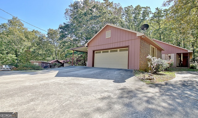 view of side of home featuring a garage