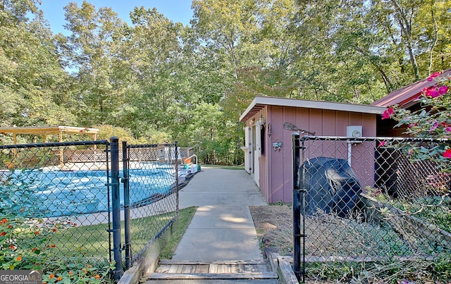 view of swimming pool with a storage shed