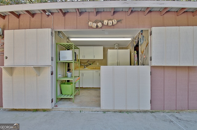 garage with sink and white fridge