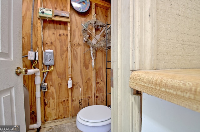 bathroom with wood walls